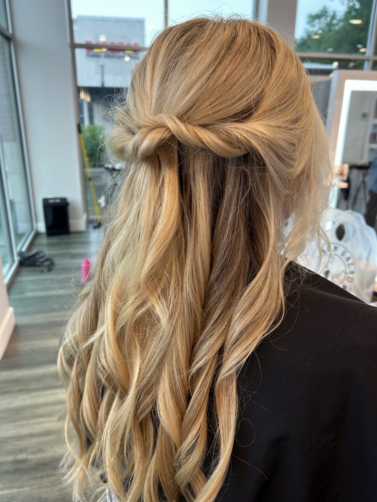 Blonde half-up event style with loose curls