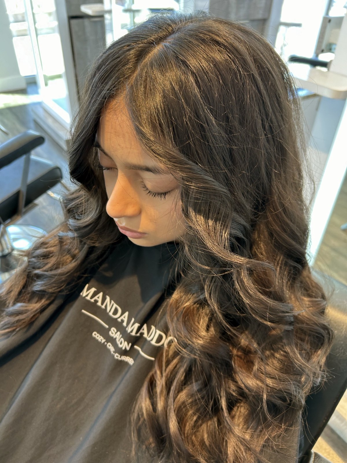 Brunette hair with warm curls and dimension